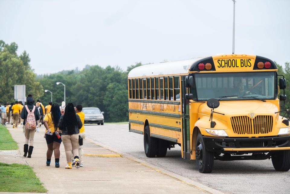 Students unload from the bus before the first day at Brewbaker Middle School in Montgomery, Ala., on Tuesday, Aug. 9, 2022.