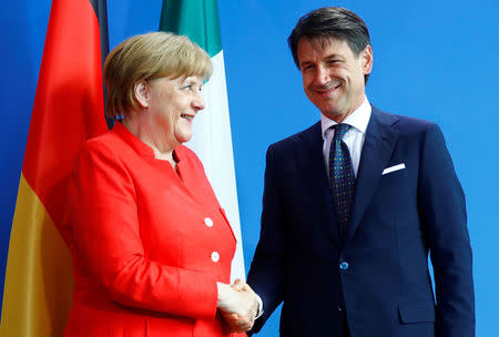 German Chancellor Angela Merkel and Italian Prime Minister Giuseppe Conte shake hands after a news conference at the chancellery in Berlin, Germany, June 18, 2018. REUTERS/Hannibal Hanschke