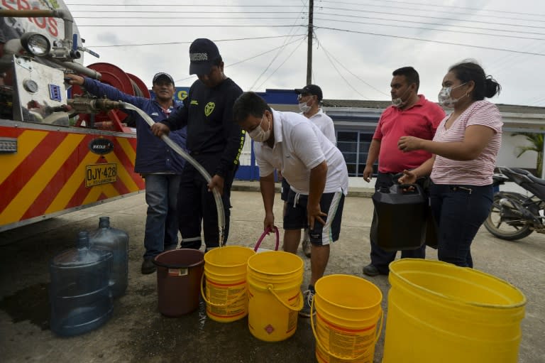 People collect water in Mocoa, on April 4, 2017 as the region struggles to recover from a devatating landslide