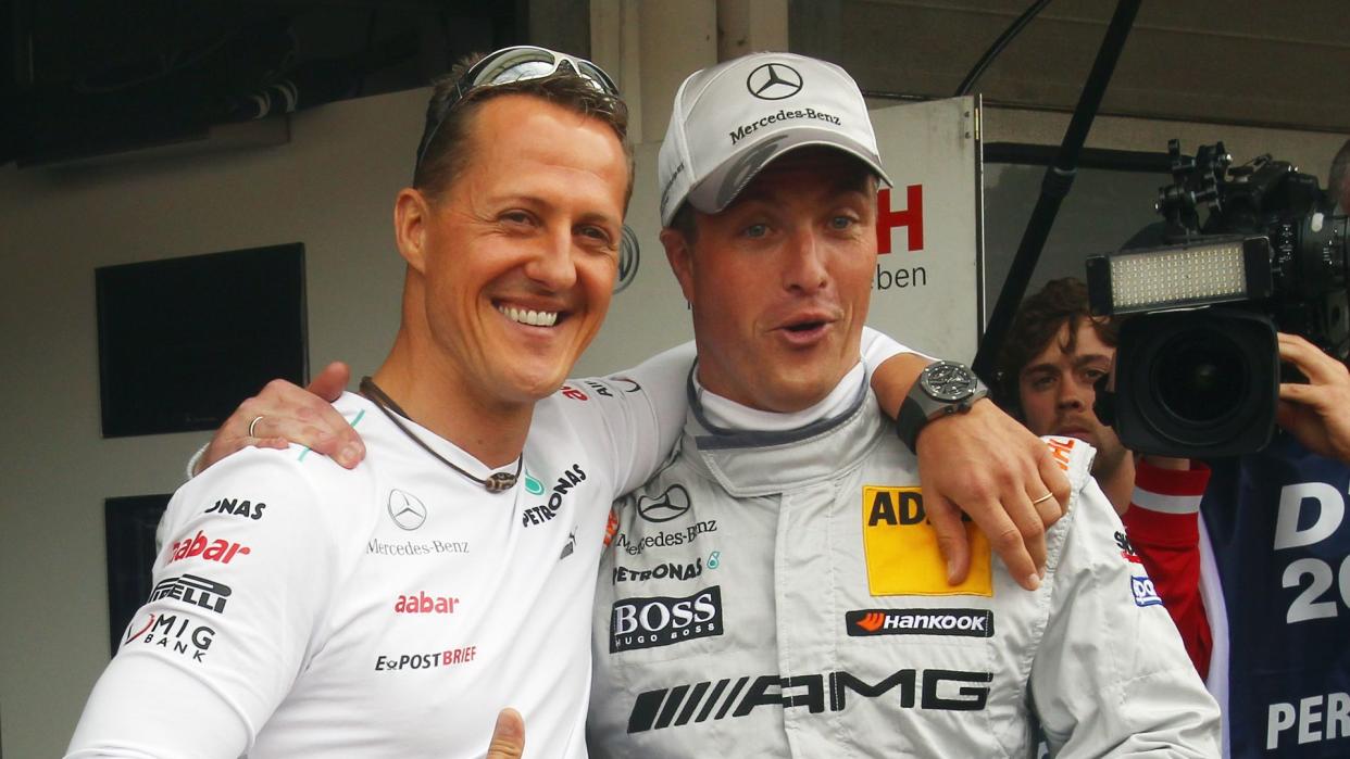 Michael Schumacher with his arm around Ralf Schumacher