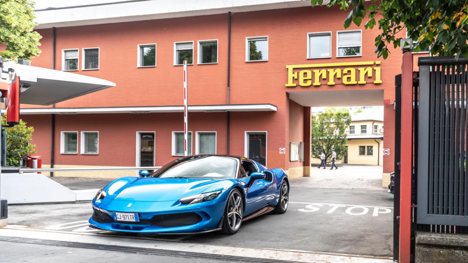 A Ferrari 296 GTB leaves the gate from Ferrari's headquarters in Maranello.