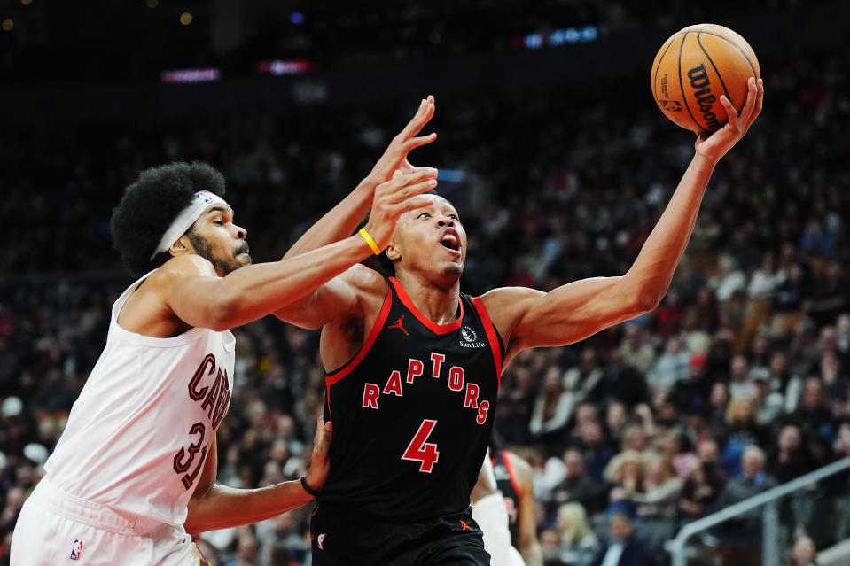 Toronto Raptors forward Scottie Barnes (4) drives past Cleveland Cavaliers centre Jarrett Allen (31) during the first half of an NBA basketball game, Saturday, Feb. 10, 2024 in Toronto. (Frank Gunn/The Canadian Press via AP)