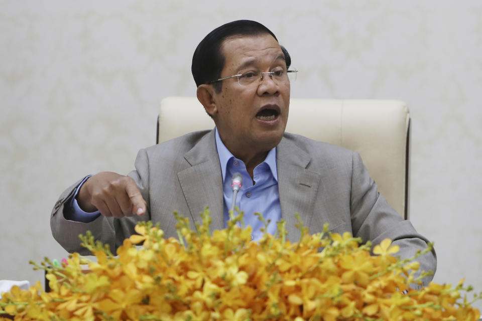Cambodia's Prime Minister Hun Sen gestures during a speech on the current state of a new virus from China in Phnom Penh, Cambodia, Thursday, Jan. 30, 2020. Cambodia's leader has urged citizens to remain calm about the new virus from China, which has been confirmed in a single case of a visitor from Wuhan. (AP Photo/Heng Sinith)