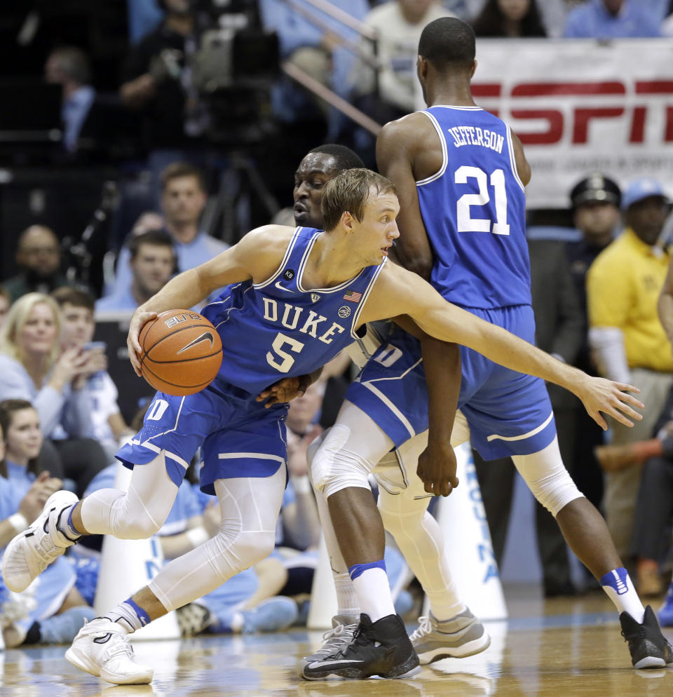 North Carolina's Theo Pinson guards Duke's Luke Kennard (5) as Duke's Amile Jefferson sets a screen during the first half of an NCAA college basketball game in Chapel Hill, N.C., Saturday, March 4, 2017. (AP Photo/Gerry Broome)