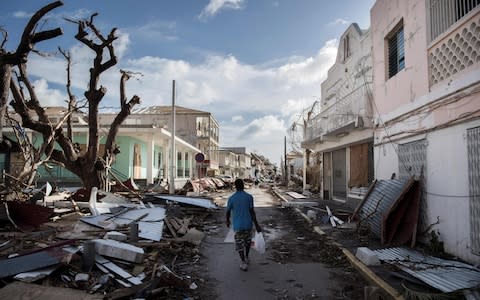  A man walks on a street covered in debris after hurricane Irma hurricane passed on the French island of Saint-Martin, near Marigot - Credit:  MARTIN BUREAU