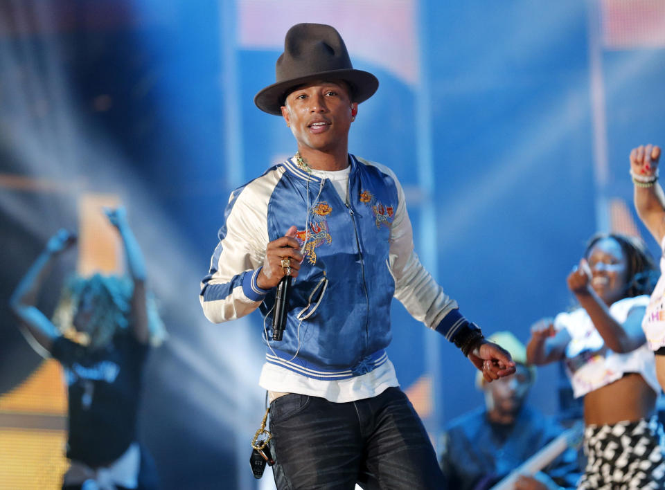 FILE - This Feb. 16, 2014 file photo shows singer-producer Pharrell Williams rehearsing before the NBA All Star basketball game in New Orleans. This week Pharrell released his sophomore solo album, “G I R L,” which features the Oscar-nominated hit, “Happy.” The song is spending its second week on top of the Billboard Hot 100 chart. (AP Photo/Bill Haber, File)