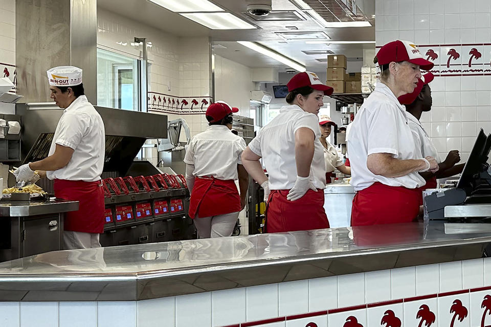 Workers prepare food and take orders an In-N-Out burger restaurant Tuesday, Aug. 8, 2023, in Thornton, Colo. On Friday, the U.S. government issues the August jobs report. (AP Photo/David Zalubowski)