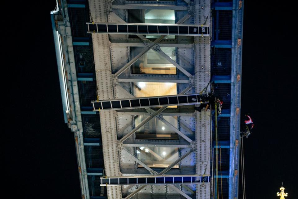 Echo: Workers from LDT Contractors cleaning Tower Bridge's glass floors