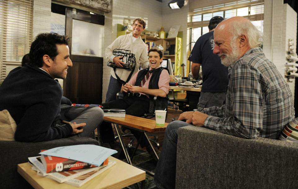 James Burrows, right, director of the television series "Partners," laughs with cast members David Krumholtz, left, and Michael Urie, seated center, on Wednesday, Sept. 19, 2012, at Warner Bros. Studios in Burbank, Calif. Burrows isn't a household name. But behind the scenes Burrows reigns as a comedy giant. He's a director whose brand of funny business has helped shape TV comedy season after season. (Photo by Chris Pizzello/Invision/AP)