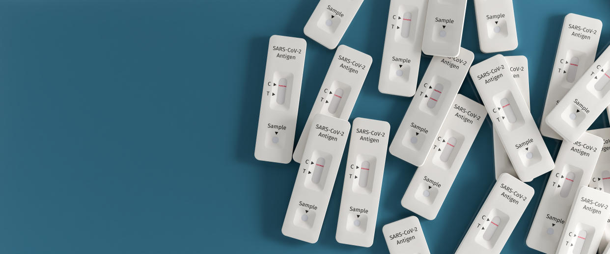 Millions of COVID-19 rapid tests in Canada are set to expire this year, but that doesn't mean they're garbage. (Getty) Mass testing for Covid-19 / SARS-CoV-2 infection concept: Several rapid antigen test kits. One kit in the middle showing a positive result (two lines visible)