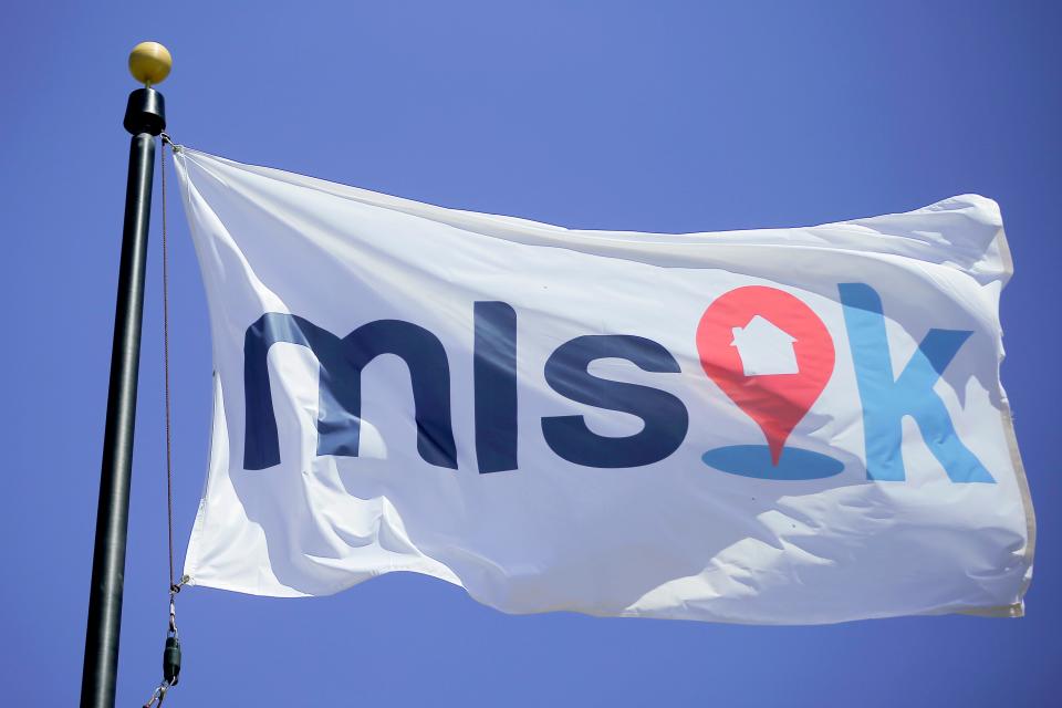 A new flag with the logo for MLSOK, the Multiple Listing Service, is among flags in a new display in front of the Oklahoma City Metro Association of Realtors office building, 3131 Northwest Expressway.