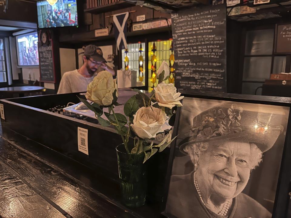 The Aldgate British pub in Tokyo’s fashionable Shibuya district Monday, Sept. 19, 2022, where Queen Elizabeth’s funeral was streaming live on several screens, where soccer games are usually shown. (AP Photo/Yuri Kageyama)