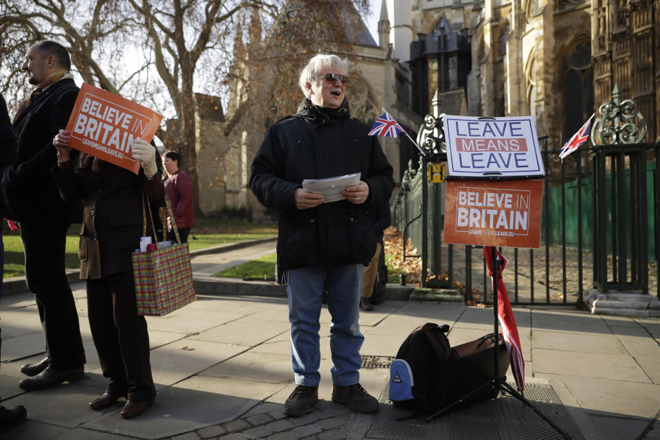 A leave the European Union, Brexit supporter protests by saying he was "taking a stand" across the street from the House of Parliament in London, Tuesday, Dec. 11, 2018. Top European Union officials are ruling out any renegotiation of the divorce agreement with Britain as Prime Minister Theresa May fights to save her Brexit deal by lobbying leaders in Europe's capitals. (AP Photo/Matt Dunham)