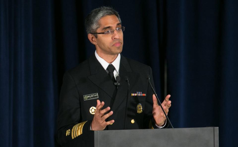 Dr Murthy speaking at a podium