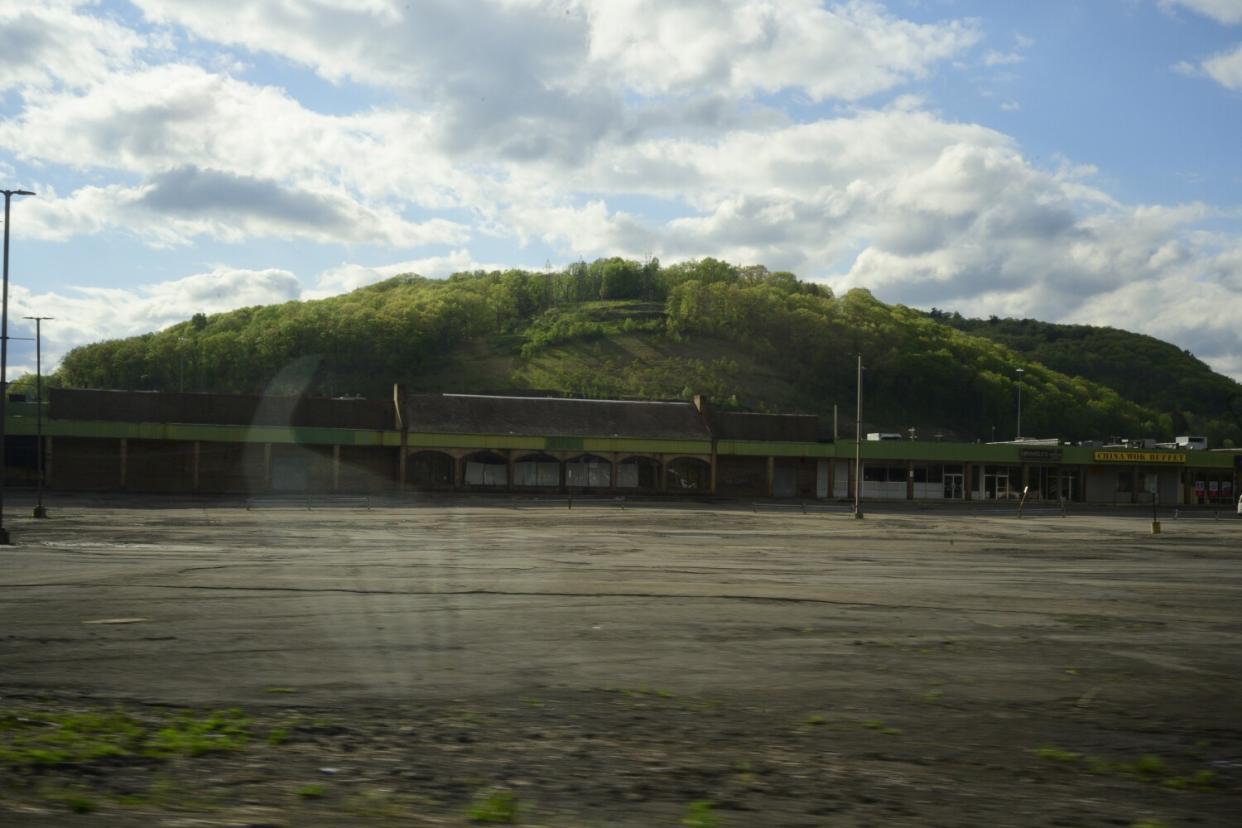 Closed stores sit behind an empty parking lot.