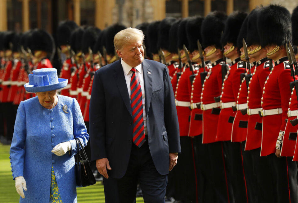 In this July 13, 2018, photo President Donald Trump and Britain's Queen Elizabeth II inspect a Guard of Honour, formed of the Coldstream Guards at Windsor Castle in Windsor, England. / Credit: Matt Dunham/AP