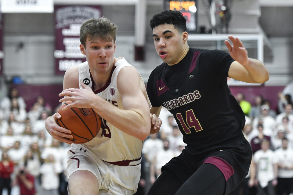 Colgate guard Tucker Richardson, left, is defended by Lafayette forward Kyle Jenkins during the second half of an NCAA college basketball game for the Patriot League tournament championship in Hamilton, N.Y., Wednesday, March 8, 2023. (AP Photo/Adrian Kraus)