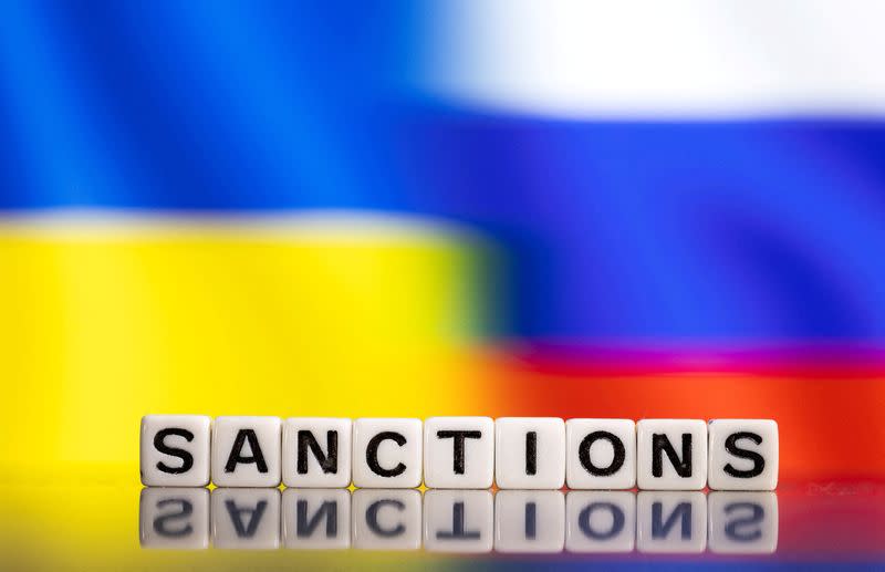 FILE PHOTO: Illustration shows letters arranged to read "Sanctions" in front of Ukraine's and Russia's flag colors