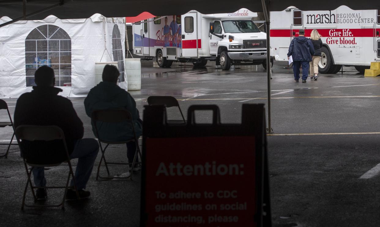 Seated in chairs set eight feet apart, blood donors wait to be taken to one of three mobile blood centers during a blood drive hosted by Marsh Regional Blood Center at the Bristol Motor Speedway Monday, March 23, 2020. With a nationwide shortage of blood supply growing, the blood drive provides local residents the opportunity to donate in a time of need due to the coronavirus pandemic.