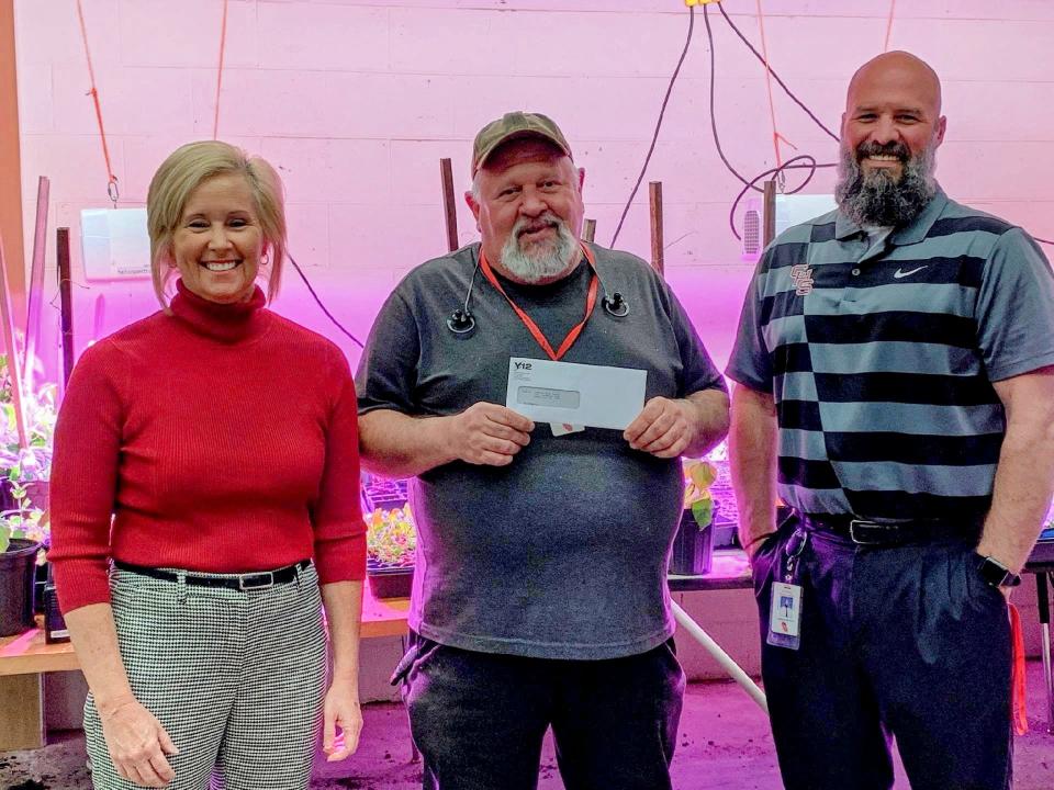 Kristin Waldschlager, Y-12 education outreach specialist, presents a grant to Gus Ferreira, agricultural science teacher, and Andrew Brown, principal at Central High School. The grant will be used for agricultural science students to build an aquaponics teaching lab that science and math students may use.