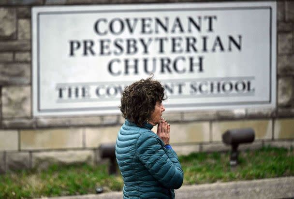 PHOTO: Robin Wolfende prays at a makeshift memorial for victims outside the Covenant School building at the Covenant Presbyterian Church following a shooting, in Nashville, March 28, 2023. (Brendan Smialowski/AFP via Getty Images)