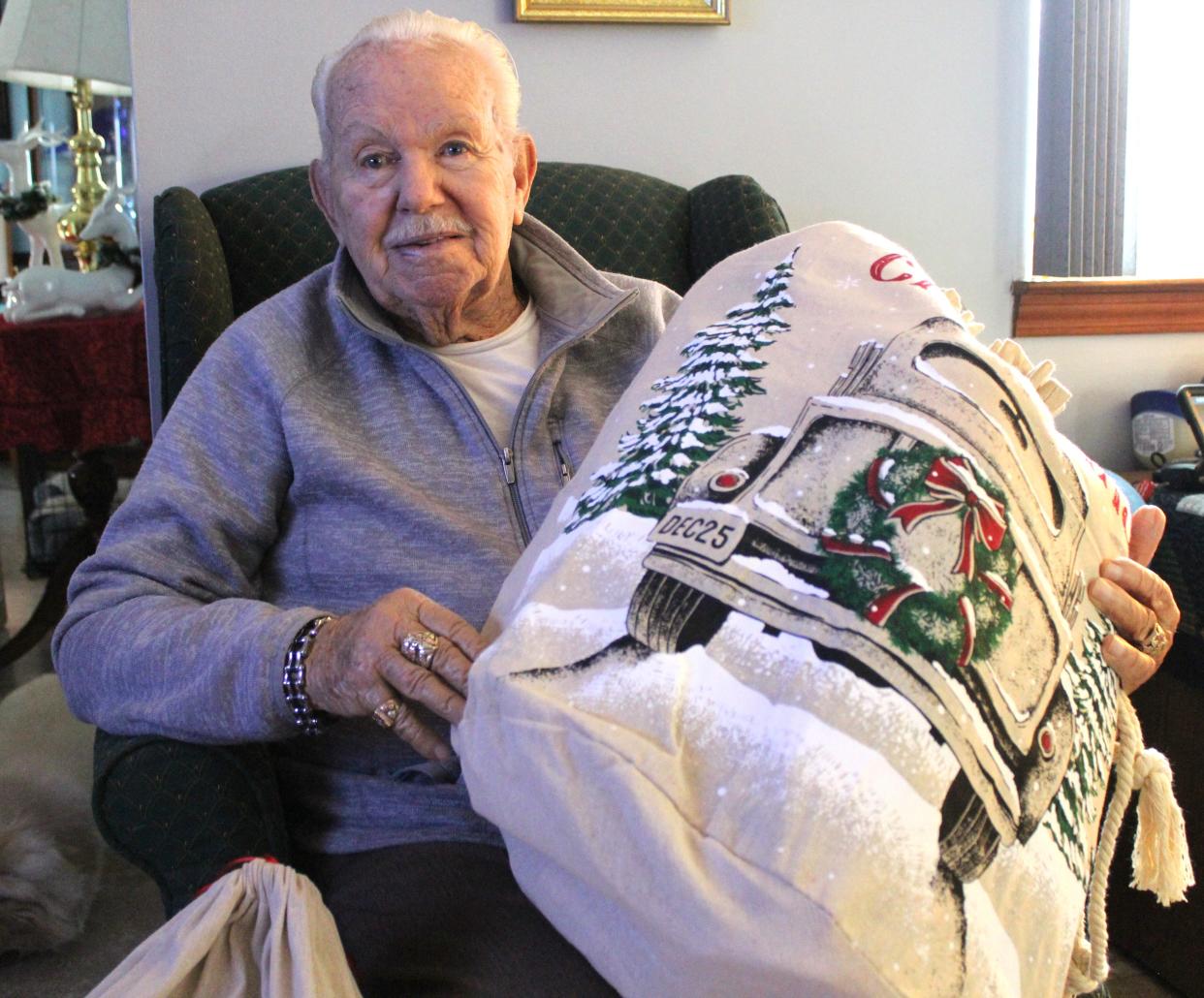 Emil Skinlo holds one of the gift bags he received from Angels 4 Vets. The 90-year-old veteran served in the Air Force for 27 years.