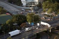 People place a barricade on a road outside the Hong Kong Polytechnic University (PolyU), in Hong Kong