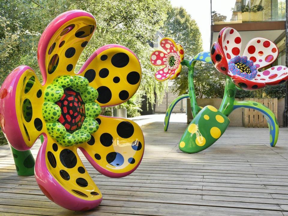 The exterior patio of the gallery is dominated by painted bronze sculptures of flowers covered in dots (Rex)