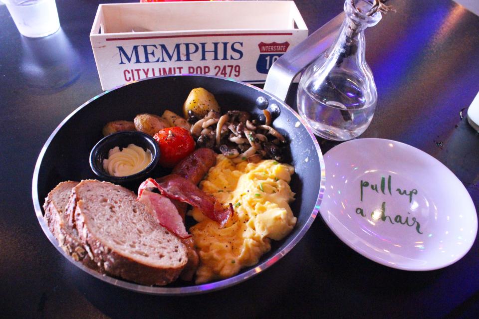 Whisk Breakfast Plate with Scrambled Eggs, Smoked Pork Sausage, Streaky Bacon, Roasted Potatoes, Roasted Cherry Vine Tomatoes, Sauteed Mushrooms, Toasts and Flavoured Butter.