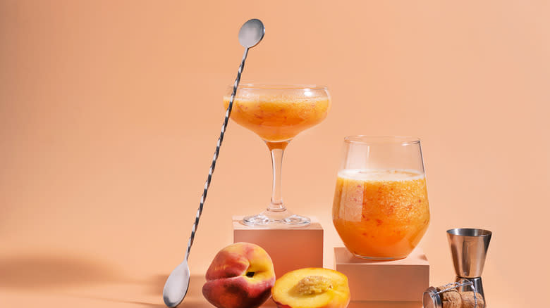 peach cocktails with cocktail spoon