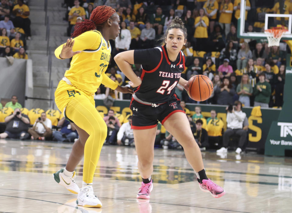 Texas Tech guard Jada Wynn, right, looks for an opening while driving around Baylor guard Aijha Blackwell in the first half of an NCAA college basketball game, Sunday, Feb. 18, 2024, in Waco, Texas. (Rod Aydelotte/Waco Tribune-Herald via AP)