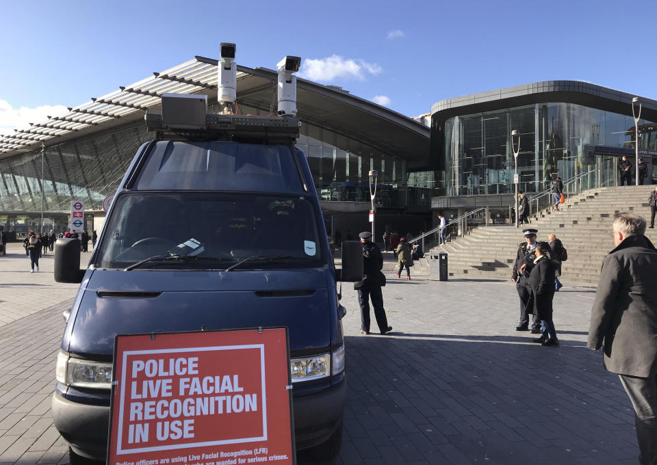 A mobile police facial recognition facility outside a shopping centre in London Tuesday Feb. 11, 2020, “We don't accept this. This isn't what you do in a democracy," said Silkie Carlo, director of privacy campaign group Big Brother Watch, who are demonstrating against the surveillance. London police started using facial recognition surveillance cameras mounted on a blue police van on Tuesday to automatically scan for wanted people, as authorities adopt the controversial technology that has raised concerns about increased surveillance and erosion of privacy. (AP Photo/Kelvin Chan)