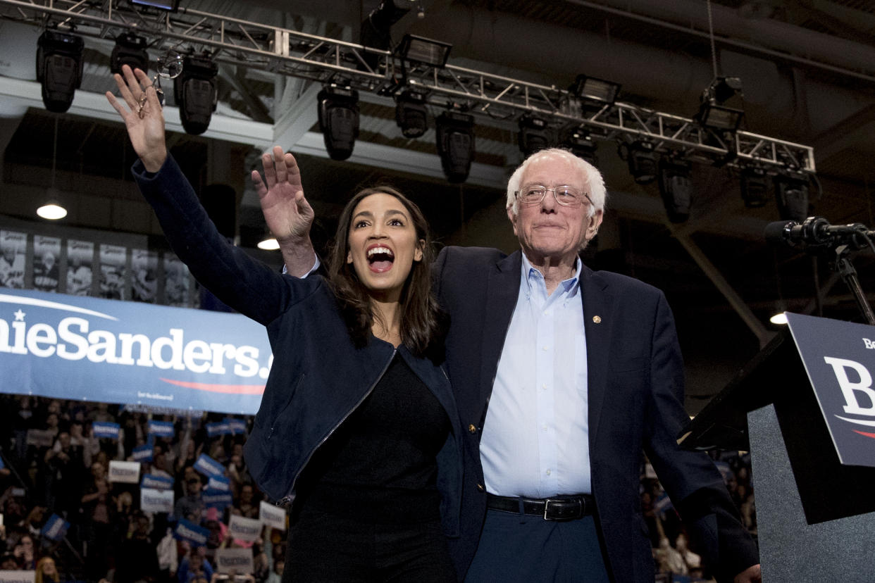 Sen. Bernie Sanders, I-Vt., accompanied by Rep. Alexandria Ocasio-Cortez, D-N.Y., left, takes the stage at campaign stop at the Whittemore Center Arena at the University of New Hampshire, Monday, Feb. 10, 2020, in Durham, N.H. (Andrew Harnik/AP)
