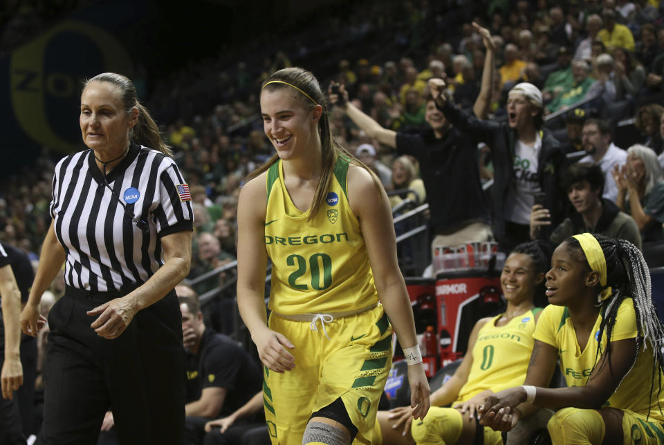 Fans react to a technical foul call, right, after Oregon's Sabrina Ionescu, center, stepped off the bench to shoot an out-of-bounds ball during the closing seconds of a first-round game against Portland State in the NCAA women's college basketball tournament Friday, March 22, 2019, in Eugene, Ore. (AP Photo/Chris Pietsch)