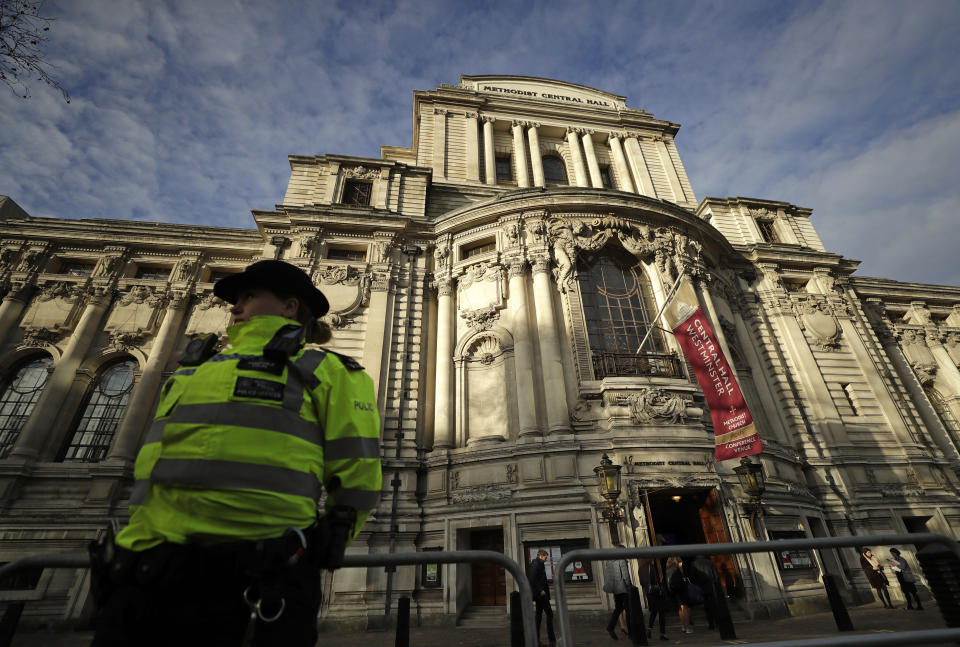 A police officer stands outside of Central Hall Westminster in London for the event 'NATO Engages' Tuesday, Dec. 3, 2019. NATO heads of state will gather later in the evening at Buckingham Palace to mark the Alliance's 70th birthday. (AP Photo/Matt Dunham)