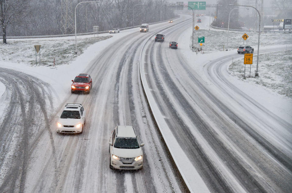 Cars drive on a snow-covered Route 422 at the Penn Street Cloverleaf in West Reading on Wednesday afternoon  December 16, 2020, during a snow storm.  / Credit: MediaNews Group/Reading Eagle via Getty