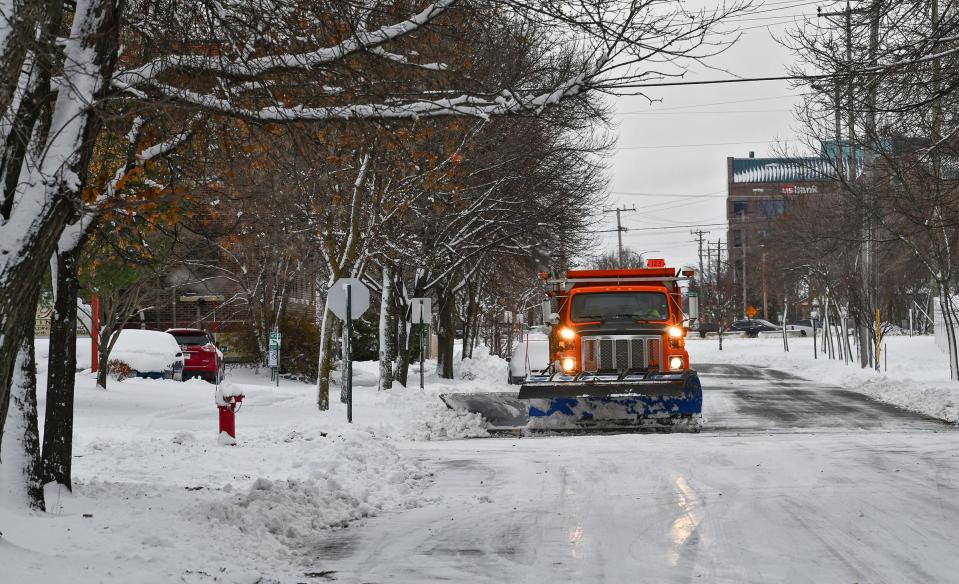 A snowplow removes about four inches of snow from a city street Wednesday, Nov. 27, 2019, in St. Cloud. 