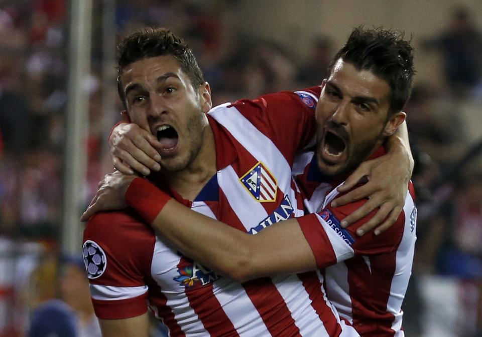 Atletico Madrid's Merodio and Villa celebrate their team's first goal against Barcelona during their Champions League quarter-final second leg soccer match in Madrid