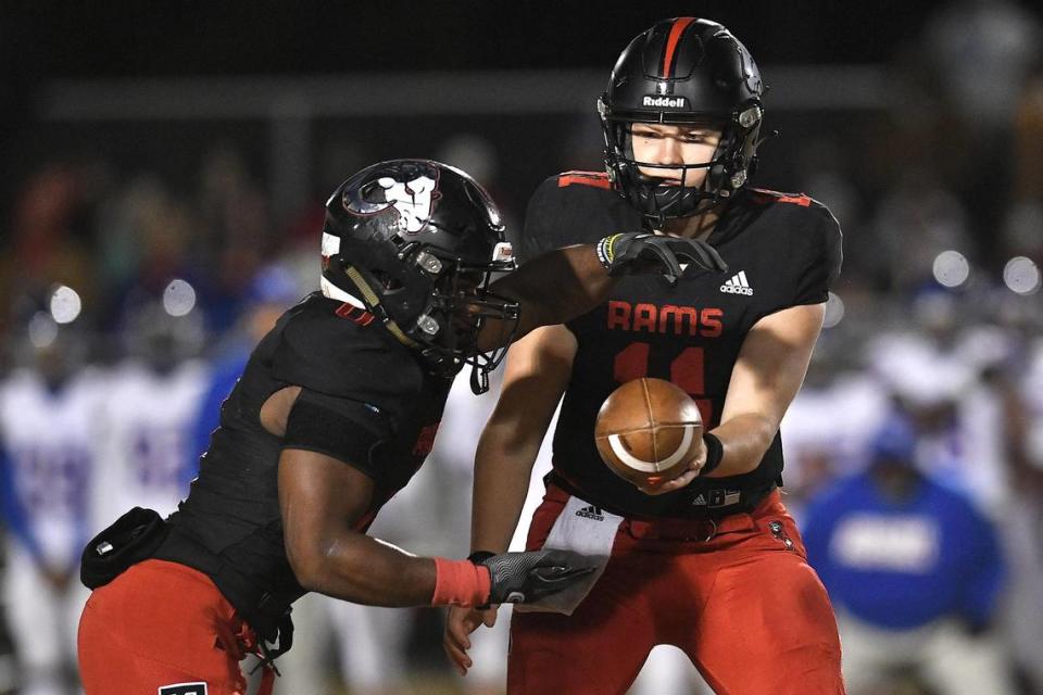 Rolesville quarterback Braden Atkinson (11) hands off the ball to running back Devon Thomas (0) during the first half. The Rolesville Rams and the Wake Forest Cougars met in the second round of the NCHSAA 4A Football Playoffs in Rolesville, N.C. on November 10, 2023.
