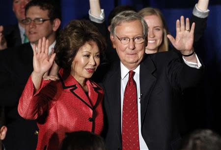 U.S. Senate Republican Leader Sen. Mitch McConnell (R-KY) and his wife Elaine Chao wave to a crowd of campaign supporters after defeating Tea Party challenger Matt Bevin in the states Republican primary elections in Louisville, Kentucky, May 20, 2014. REUTERS/John Sommers II