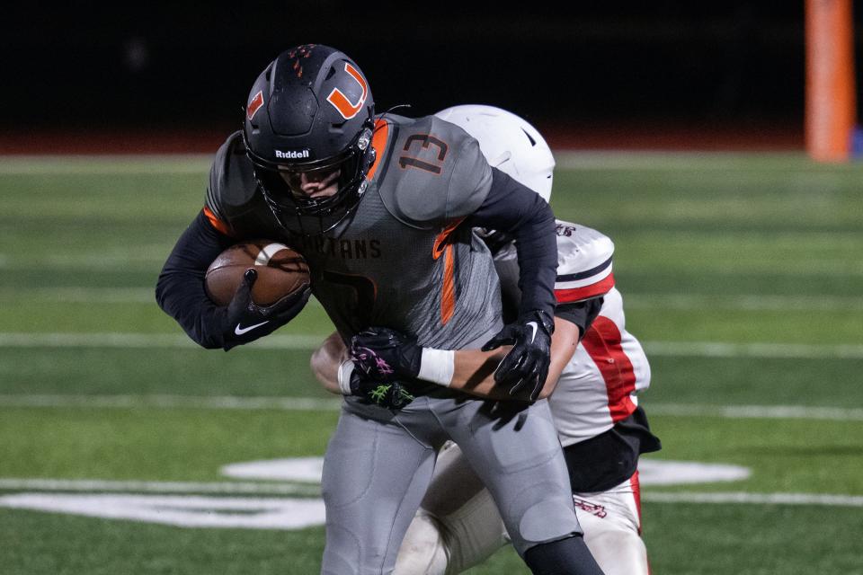 Uxbridge's Carter Gilmore is tackled by South High's Ayden Pugliese.