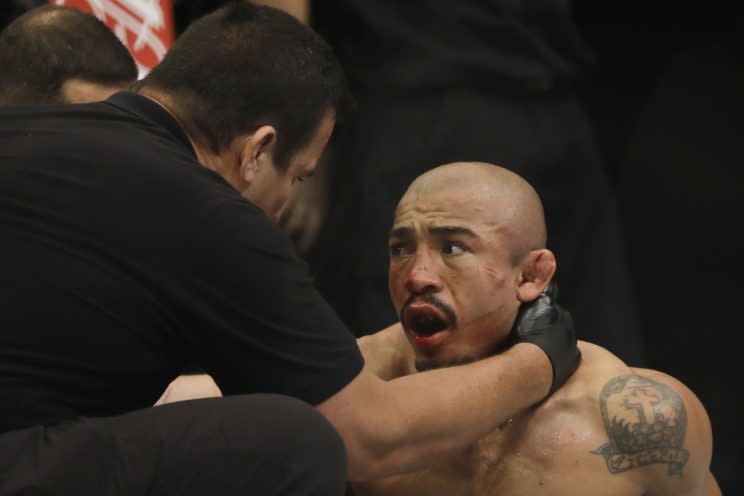 Referee “Big” John McCarthy checks on Jose Aldo after stopping his bout with Max Holloway Saturday in the third round of the main event of UFC 212 in Rio de Janeiro. (The Associated Press)