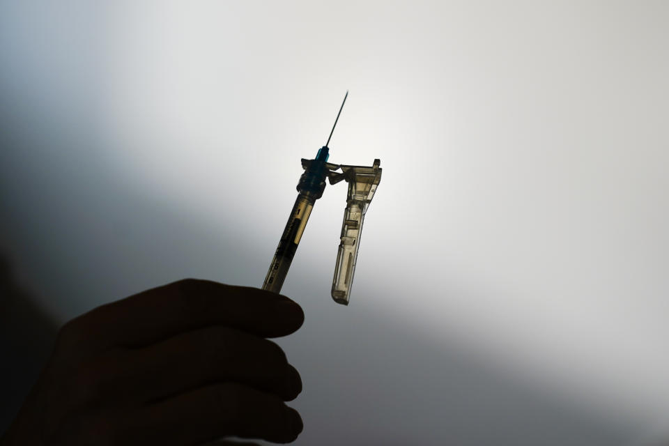 FILE - A syringe is prepared at a clinic in Norristown, Pa., Dec. 7, 2021. The Environmental Protection Agency is warning residents in 13 states and Puerto Rico about potential health risks from emissions of ethylene oxide, a chemical widely used to sterilize medical equipment and decontaminate spices. (AP Photo/Matt Rourke, File)