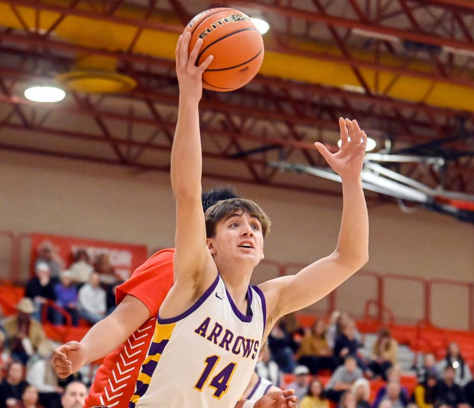 Watertown's Will Engstrom (14) grabs a rebound in front of a Rapid City Central defender during their high school boys basketball game on Saturday, Jan. 21, 2023 in Naasz Gymnasium.