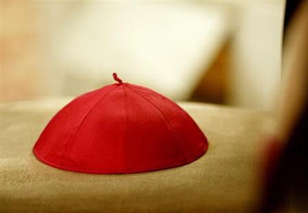 A cardinal's cap lies on a chair during a ceremony in St. Peter's Basilica presided over by Pope John Paul II April 21, 2002.