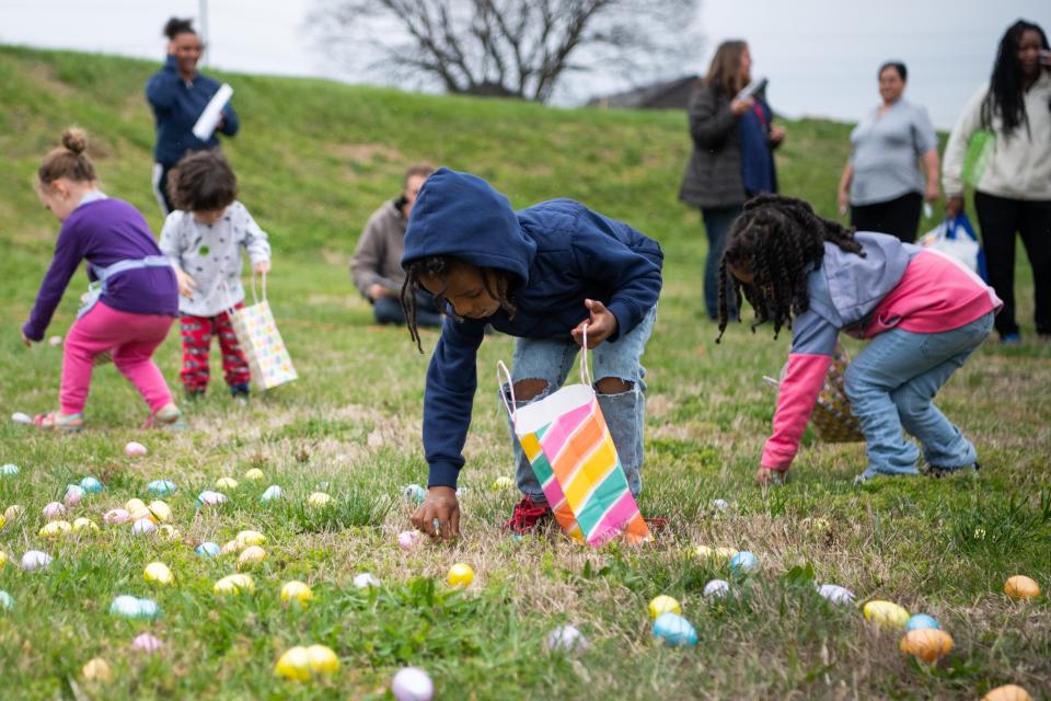 Children collect plastic eggs during an Easter egg hunt hosted by Knoxville's Community Development Corporation at Knoxville's Western Heights community held on Monday, April 3, 2023.