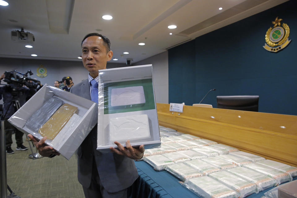 Head of Customs Drug Investigation Bureau Hui Wai-ming holds the seized cocaine during a news conference in Hong Kong, Thursday, April 4, 2019. A haul of cocaine with an estimated market value of $13 million has been seized in Hong Kong, customs agents said Thursday.(AP Photo/Kin Cheung)