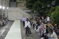 Models wear creations as part of the Hermes men's Spring Summer 2023 collection presented in Paris, France, Saturday, June 25, 2022. (AP Photo/Francois Mori)