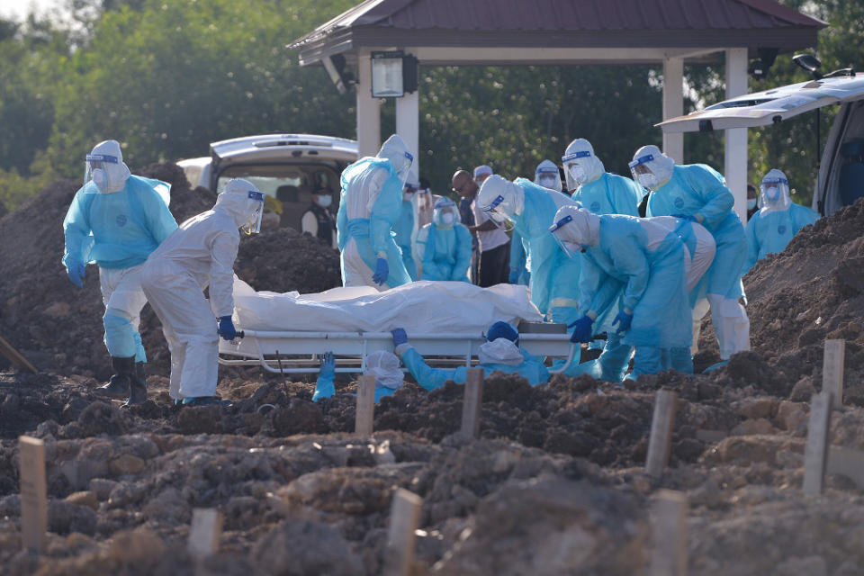 Health personnel bury the body of a Covid-19 victim at the Islamic cemetery in Klang August 6, 2021. ― Picture by Miera Zulyana