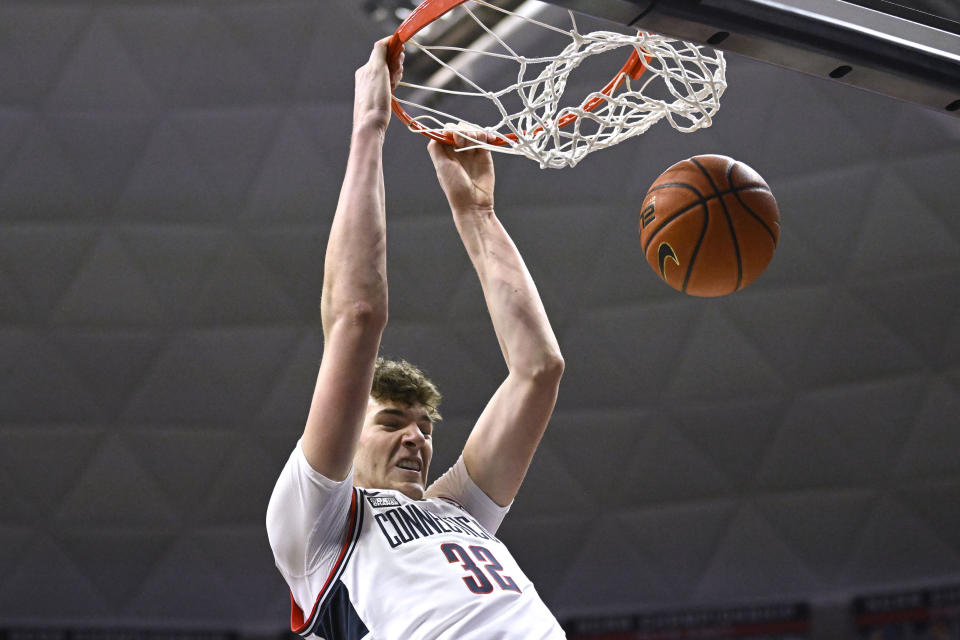 UConn's Donovan Clingan (32) dunks the ball in the first half of an NCAA college basketball game against Seton Hall, Saturday, Feb. 18, 2023, in Storrs, Conn. (AP Photo/Jessica Hill)